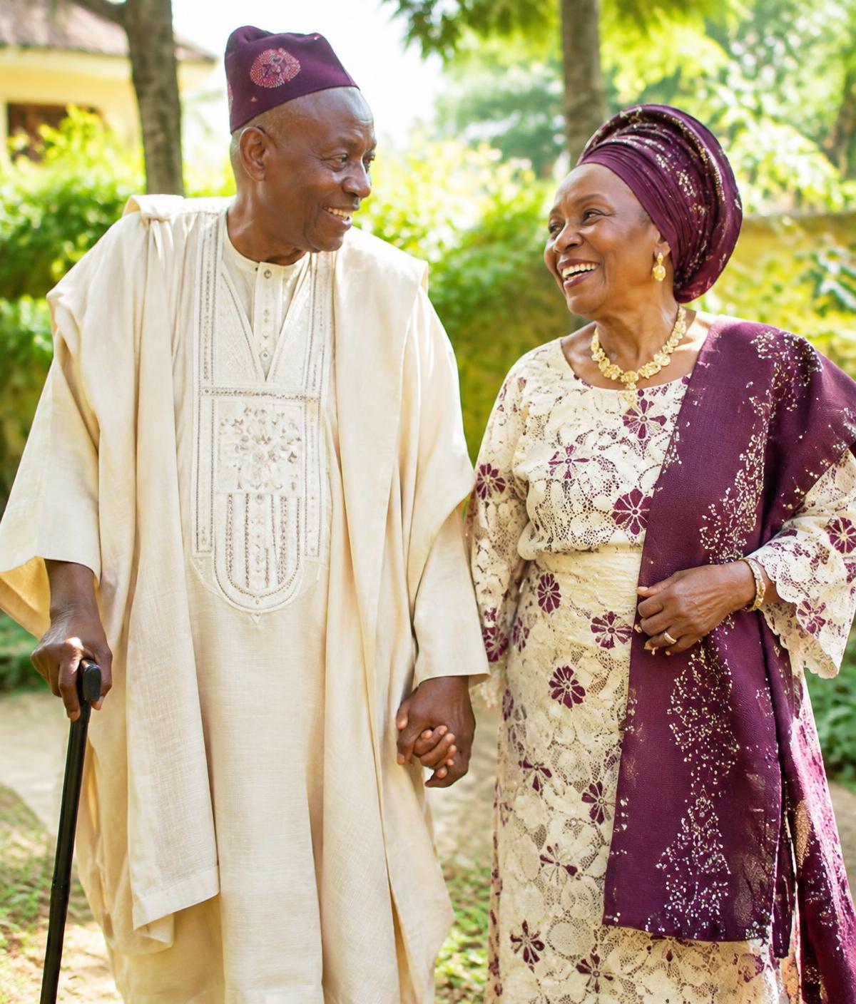 Illustrative image of an elderly couple walking hand in hand